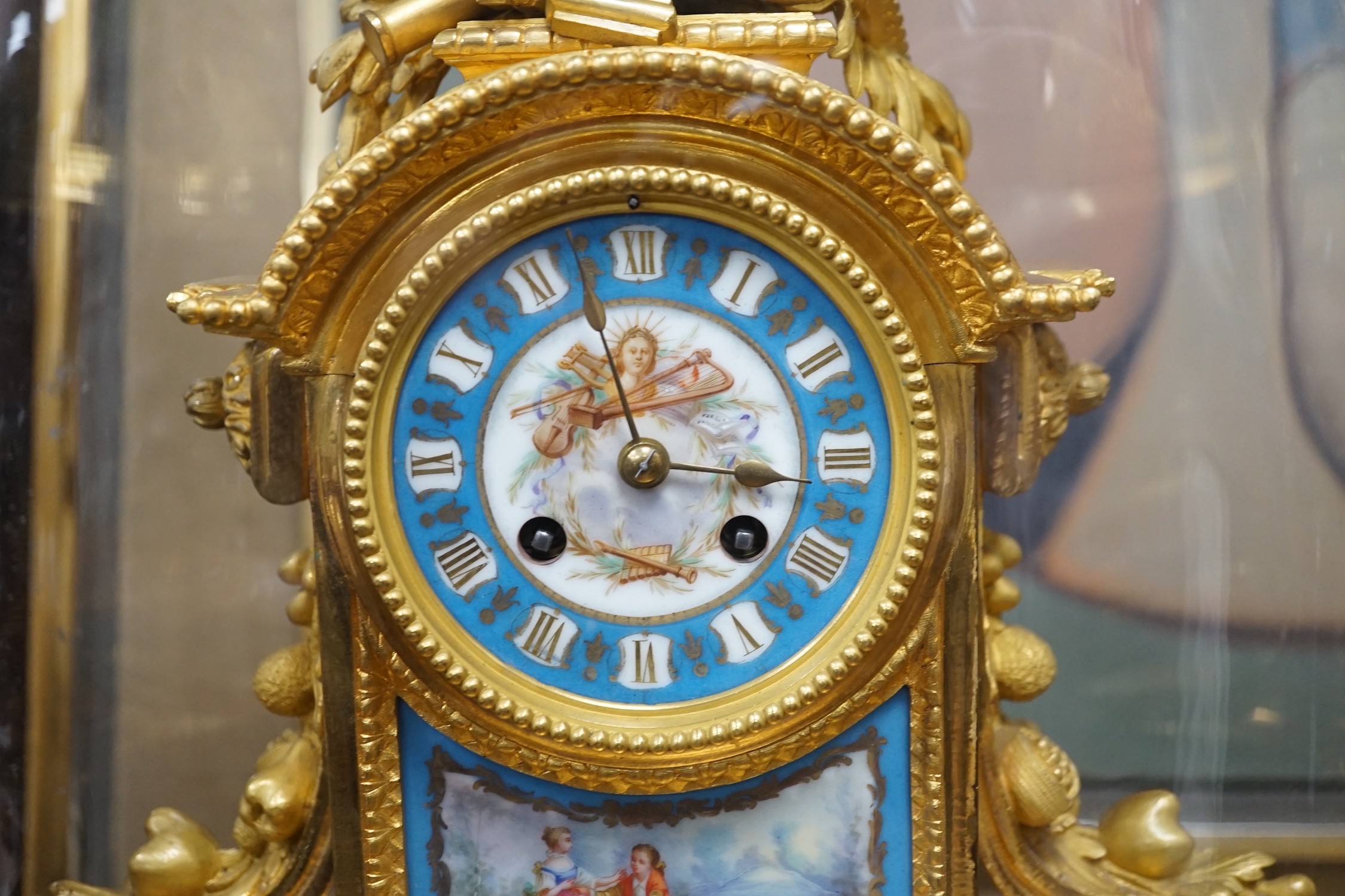 A late 19th century French ormolu and Serves style porcelain mounted mantel clock